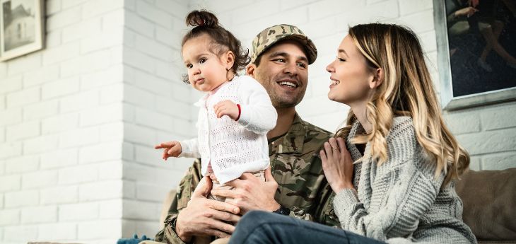 a man holding a baby and a woman holding a baby